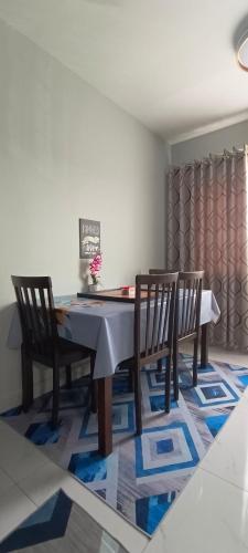 a dining room with a table and two chairs at M.FR Homestay Pangsapuri Putra Damai in Putrajaya