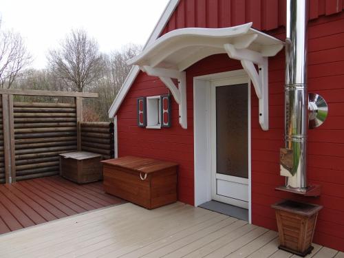 a red house with a white door and a porch at Ferienhaus Achtein in Westoverledingen