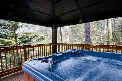 a hot tub on the deck of a cabin at The Lodge at Glades by Avada Properties in Gatlinburg