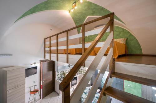 a room with a bunk bed and a spiral staircase at Appartamento Green in Giurdignano