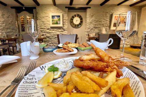 a table with a plate of fried food on it at The Wensleydale Heifer in Leyburn