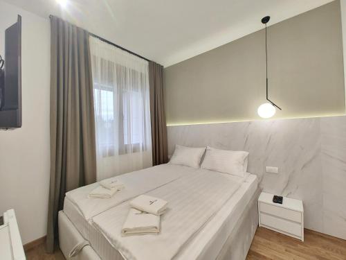 Ένα ή περισσότερα κρεβάτια σε δωμάτιο στο Apartmani Magnet Zlatibor