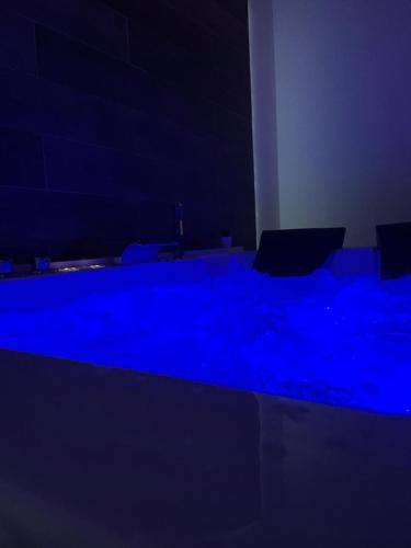 a dark room with blue lights on a table at A quel paese rooms in Rosolini