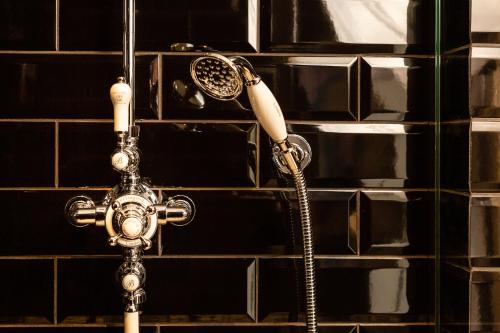 a shower in a bathroom with a faucet at R13 - A Townhouse Hotel in Reykjavík