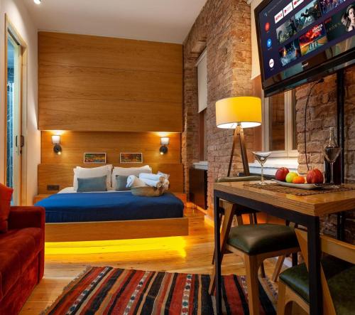 a bedroom with a bed and a flat screen tv at Kumbaracı Apartments & Suites in Istanbul