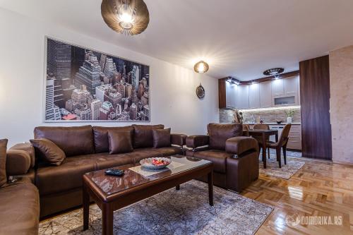 a living room with a couch and a table at Lux Lukom in Bajina Bašta