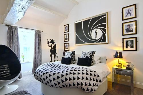a bedroom with a bed with a black and white comforter at The Wensleydale Heifer in Leyburn