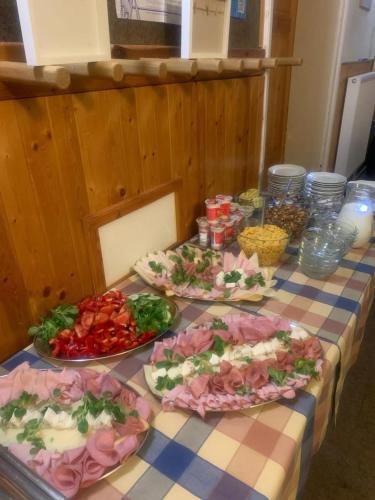 a table with four plates of food on it at Penzion Villa in Janske Lazne