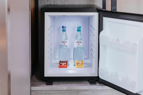 two bottles of beer in an open refrigerator at Premier Inn Köln City Mediapark in Cologne