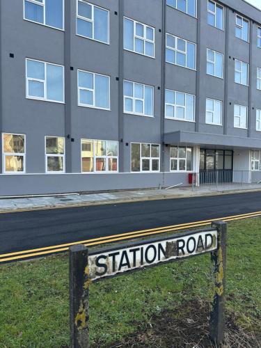 a station road sign in front of a building at Train Station Aparthotel - Free Wifi, Free Parking in Scunthorpe