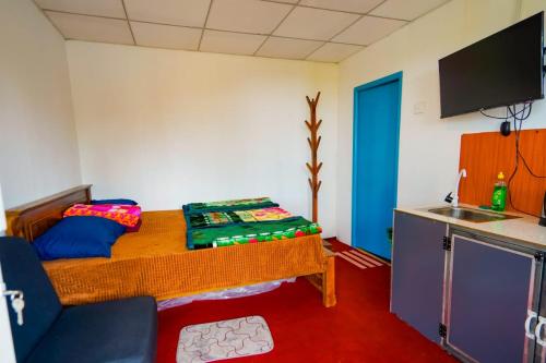 a room with a couch and a table in a room at Himalaya cabin in Nuwara Eliya