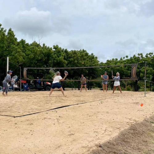 a group of people playing a game of volleyball at Pitahaya Retreat - Cozy Glamping Escape in Cabo Rojo