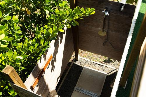 a garden with a shower and a bush at Pitahaya Retreat - Cozy Glamping Escape in Cabo Rojo