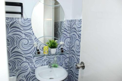 a bathroom with a sink and a mirror at EC Tamayo House Rental in Bangad