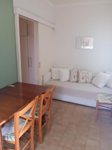 a living room with a table and a couch at Skipper's Apartments in Akrata