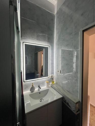 a bathroom with a sink and a mirror at Sea view Captain Apartment Durres in Durrës