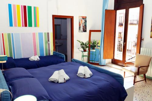 a bedroom with two blue beds with towels on it at Casa di Chiara in Crotone