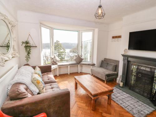 a living room with a couch and a fireplace at Afallon in Menai Bridge