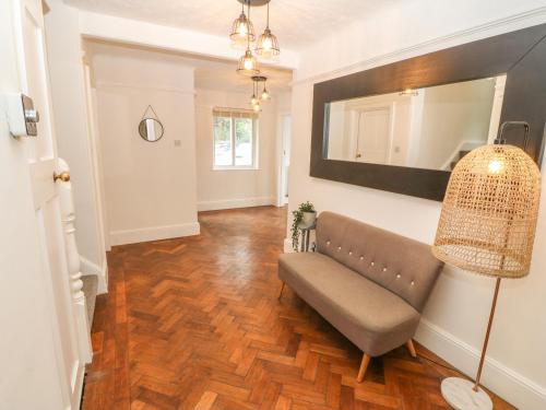 a living room with a couch and a mirror at Afallon in Menai Bridge