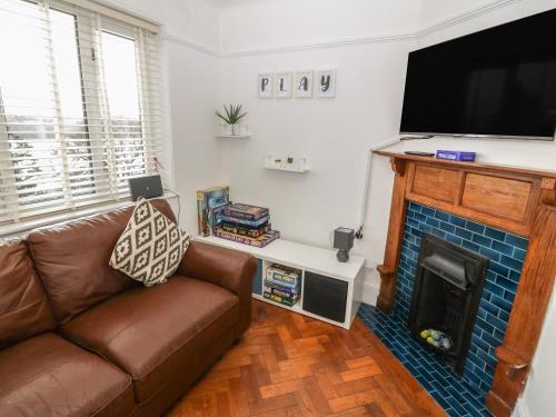 a living room with a couch and a fireplace at Afallon in Menai Bridge