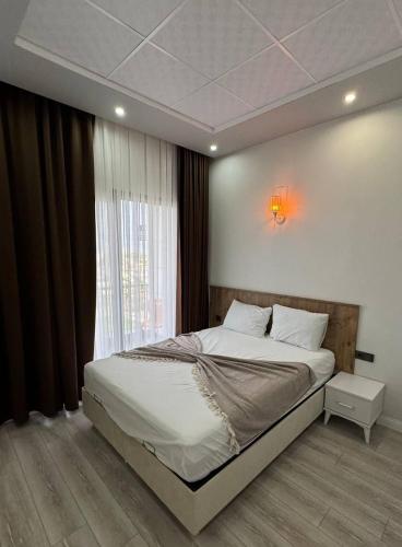 a bedroom with a large bed and a window at SG RESORT Apart Otel in Silifke