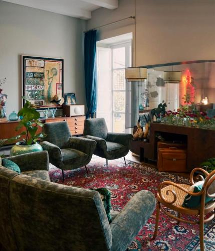 a living room with couches and chairs and a mirror at Accademia 39 in Sorrento