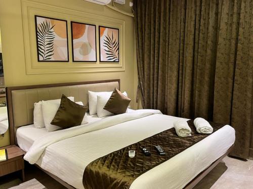 a hotel room with two beds and a window at Kedari Residency in Yeraoda