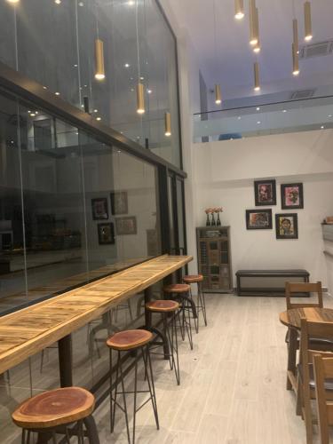 a bar in a restaurant with stools and tables at Accra Luxury Apartments at The Gallery in Accra