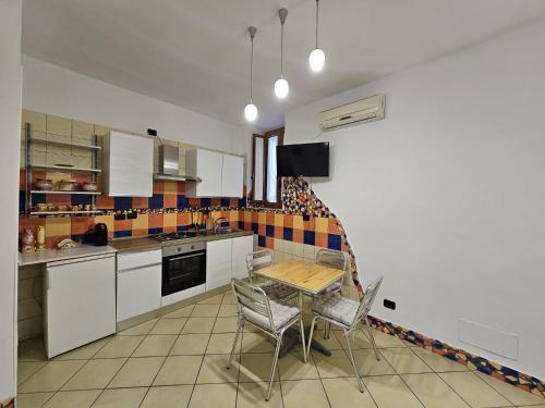 a kitchen with a table and chairs in it at CasaFiore Guest House in Vietri sul Mare
