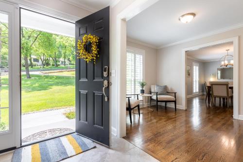 a door leading into a dining room with a table and a dining room at The Eloise by Stay Local Nashville in Nashville