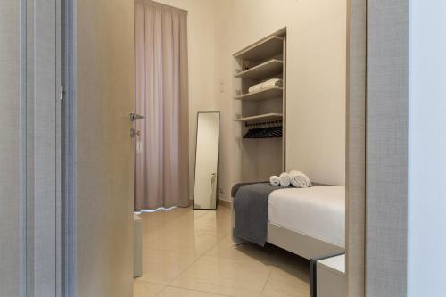 a bedroom with a bed and a walk in closet at Palazzo Di Paola - Residenza Storica in LʼAquila