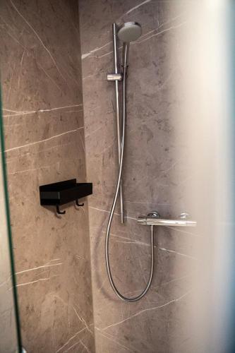 a shower with a shower head in a bathroom at Berghaus Schäfer in Faschina