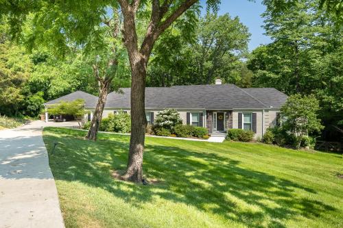 a house with a green yard with trees at The Eloise by Stay Local Nashville in Nashville