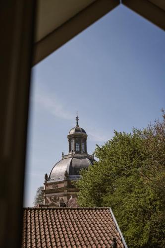 a building with a cross on top of a roof at 't Buitenverblijf, gratis parkeren in Middelburg