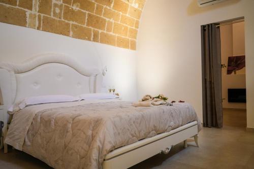 a bedroom with a bed with a stuffed animal on it at MAGNIFICAT luxury rooms in Matera