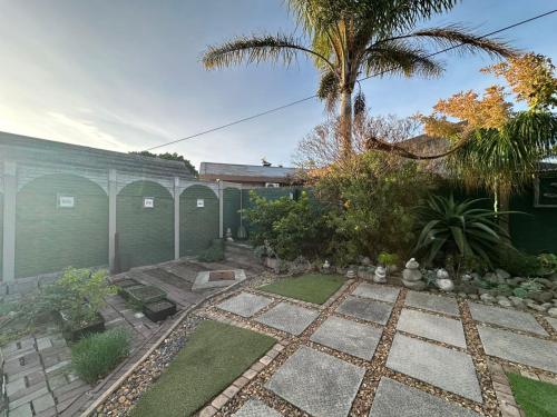 a garden in front of a building at Suite Dreams Adorable One Bedroom Apartment in Panorama