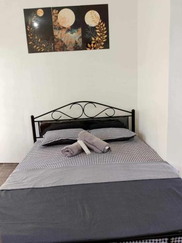 a bed with a pair of socks laying on it at EC Tamayo House Rental in Bangad