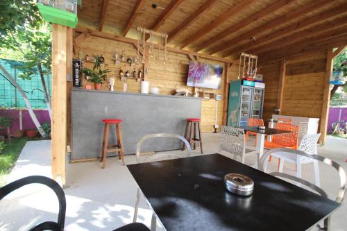 a patio with a table and chairs and a bar at Vila Bajrami in Vlorë