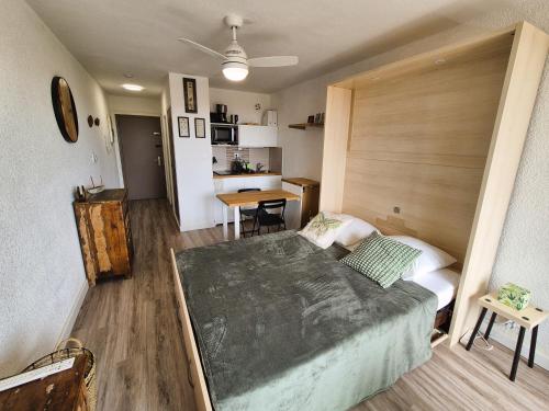 une chambre avec un grand lit et une table dans l'établissement Studio refait à neuf, vue mer, proche des plages et des commerces..., à Saint-Mandrier-sur-Mer