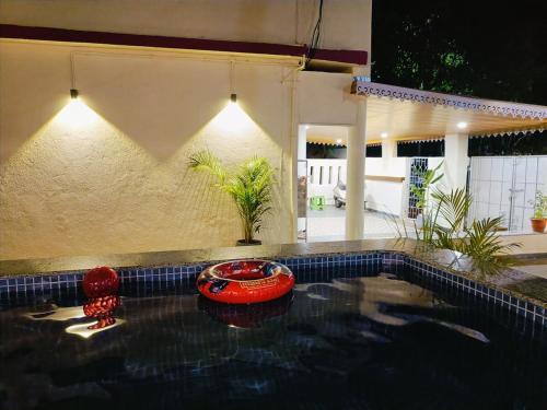 a swimming pool with a red car in a house at Zuluk Luxury Pool Villa with Swimming Pool in Ratnagiri