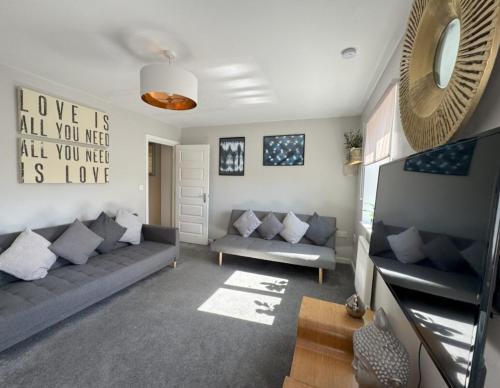 a living room with a couch and a table at Stylish 5BR Townhouse in Manor