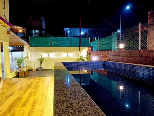 a swimming pool in a house at night at Zuluk Luxury Pool Villa with Swimming Pool in Ratnagiri