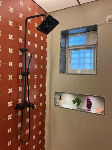 a shower in a bathroom with a window at Zuluk Luxury Pool Villa with Swimming Pool in Ratnagiri