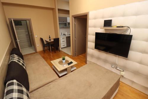 a living room with a couch and a flat screen tv at Luxury Skopje Apartments Premium in Skopje