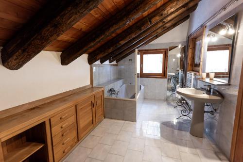 a bathroom with a sink and a toilet and a tub at Chaletbethere in Pila