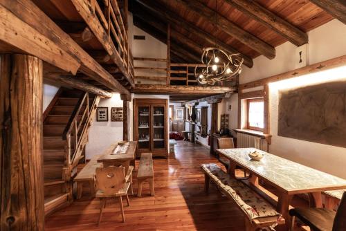 a large room with wooden floors and a table and chairs at Chaletbethere in Pila