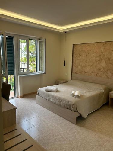 a bedroom with a large bed and a large window at Vittorio Veneto Accomodation - Tropea city center in Tropea