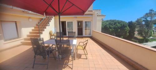 a patio with a table and chairs on a balcony at Jordi's Flat close to the Beach in L'Estartit