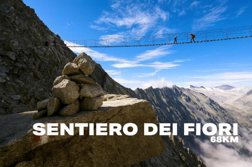a picture of a mountain with a suspension bridge in the background at La rocca - private Garden in Darfo