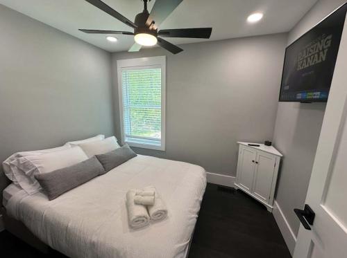 a bedroom with a bed with a ceiling fan at The Cove at Lake Murray in Chapin